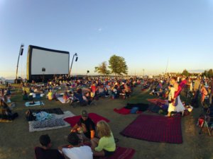 Outdoor Movie Screen at Dusk with Excited Audience