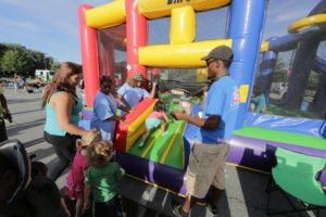 children enjoy the bouncy castle at the 19th annual comcast outdoor film festival