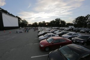 cars line up to catch the outdoor flick at the comcast outdoor film fest